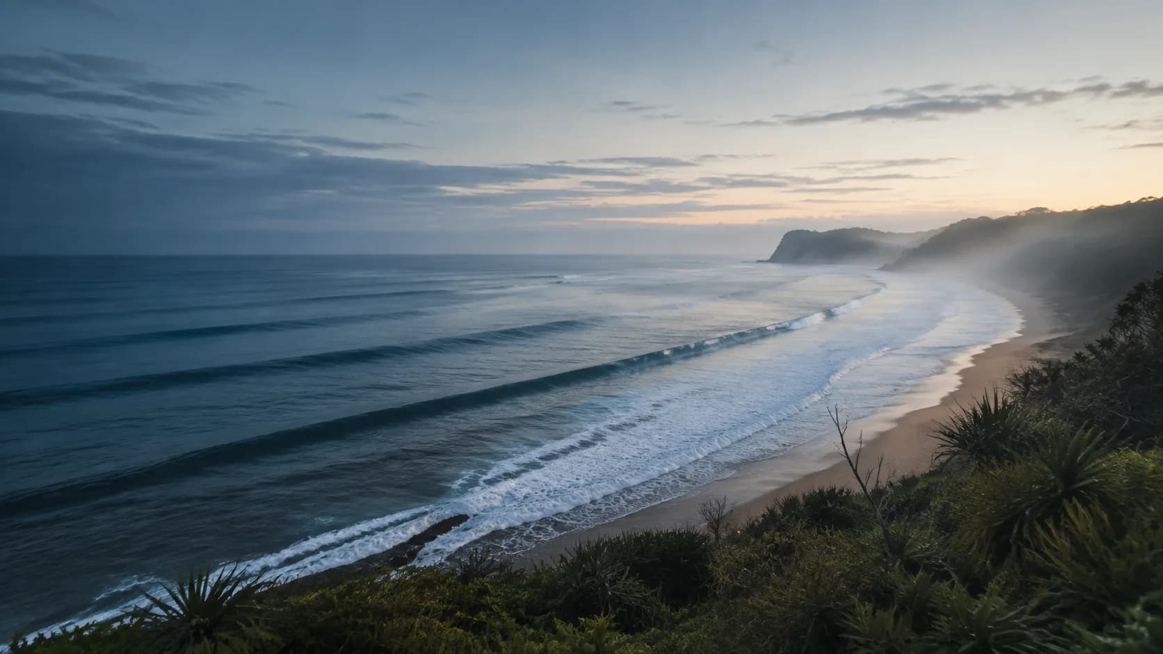 Early-morning Indonesian coastline with long swell lines