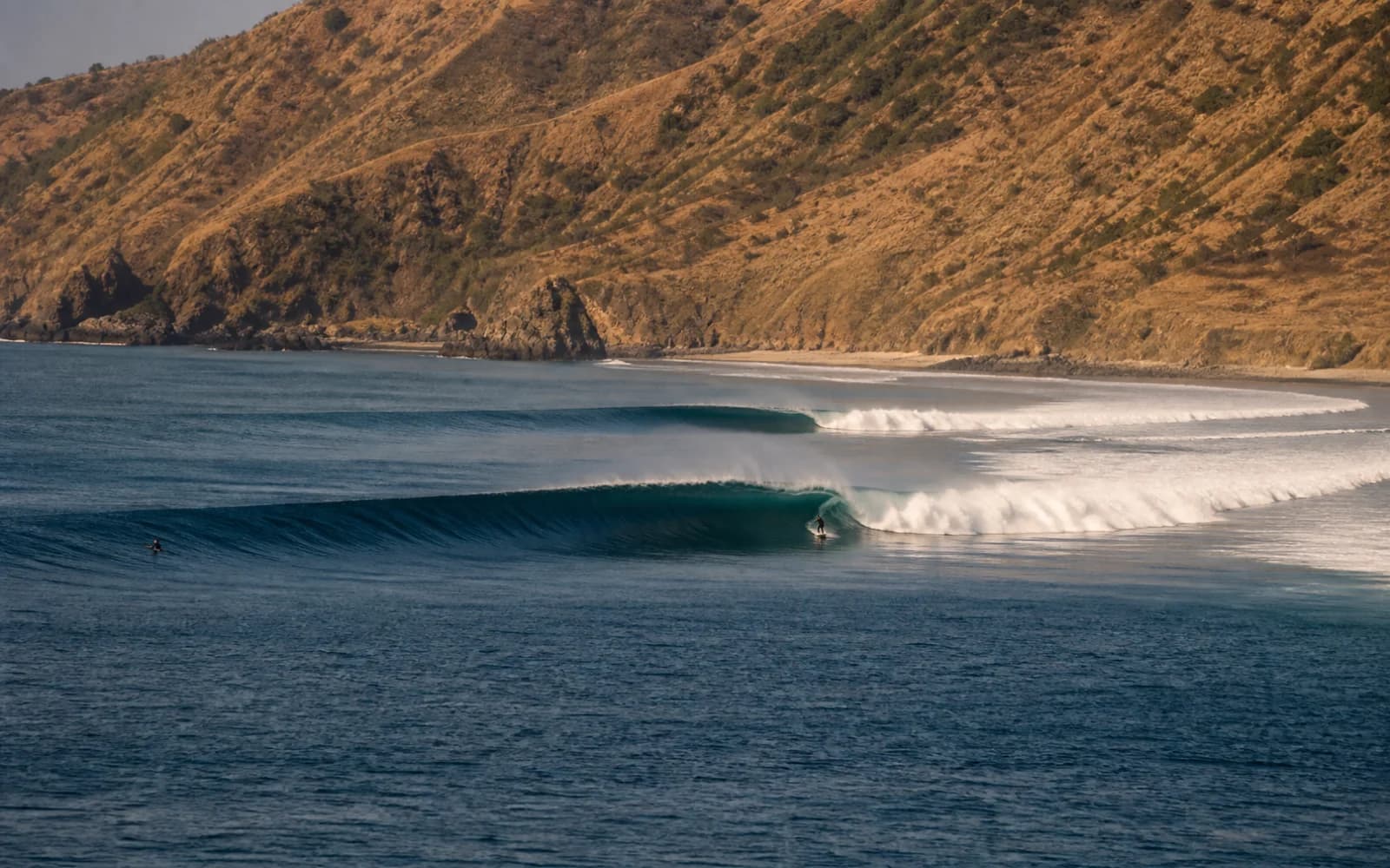 A breaking Indonesian reef wave viewed from the coast